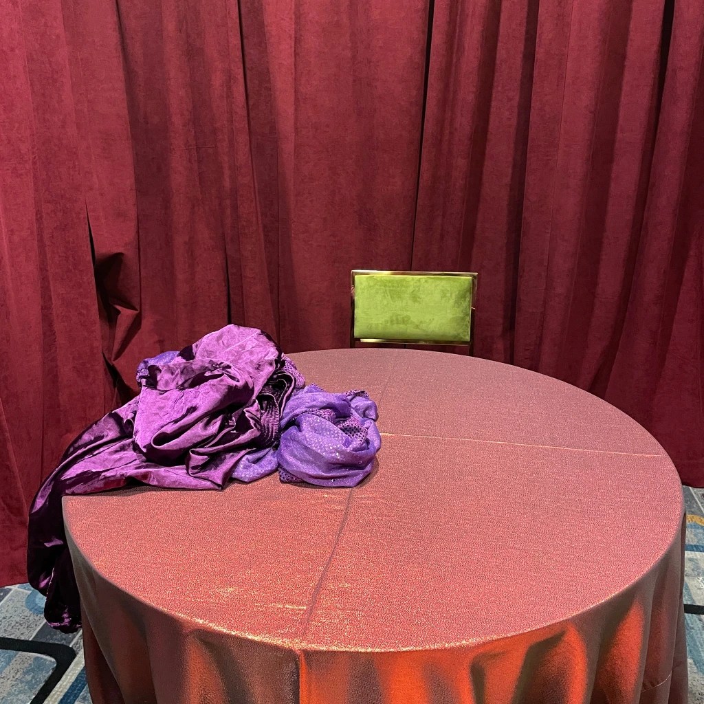 red table cloth on a table with a red curtain behind it