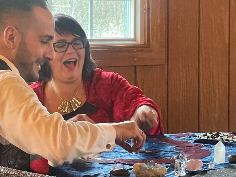 Man getting a reading from Izolda with cards and crystals on a table