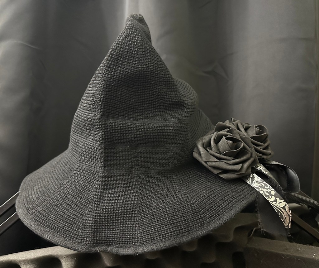 black knit hat with black rose fascinator