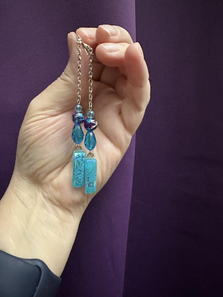 hand holding earrings