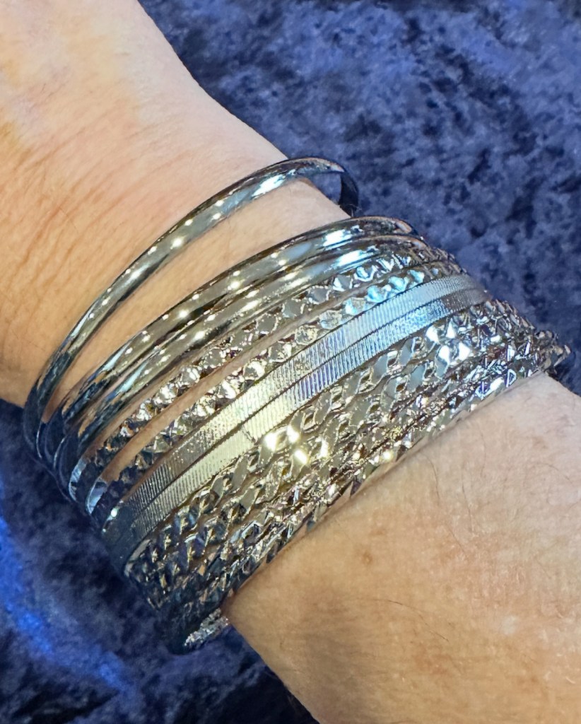 silver bracelets on an arm