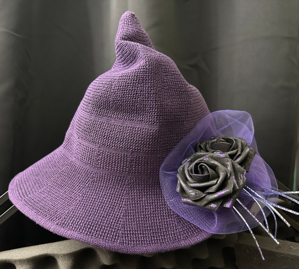purple knit hat with purple fascinator